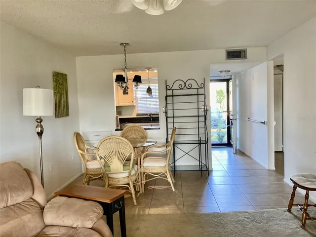 a dining room with furniture and wooden floor