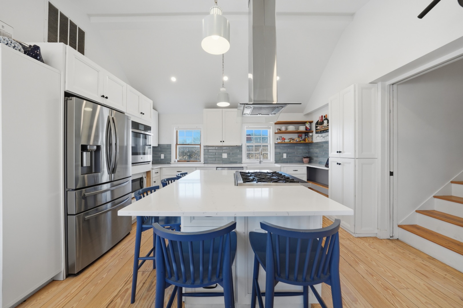 1 H Street Nantucket, MA 02554 - Photo 4 of 18 a kitchen with stainless steel appliances a dining table chairs refrigerator and sink