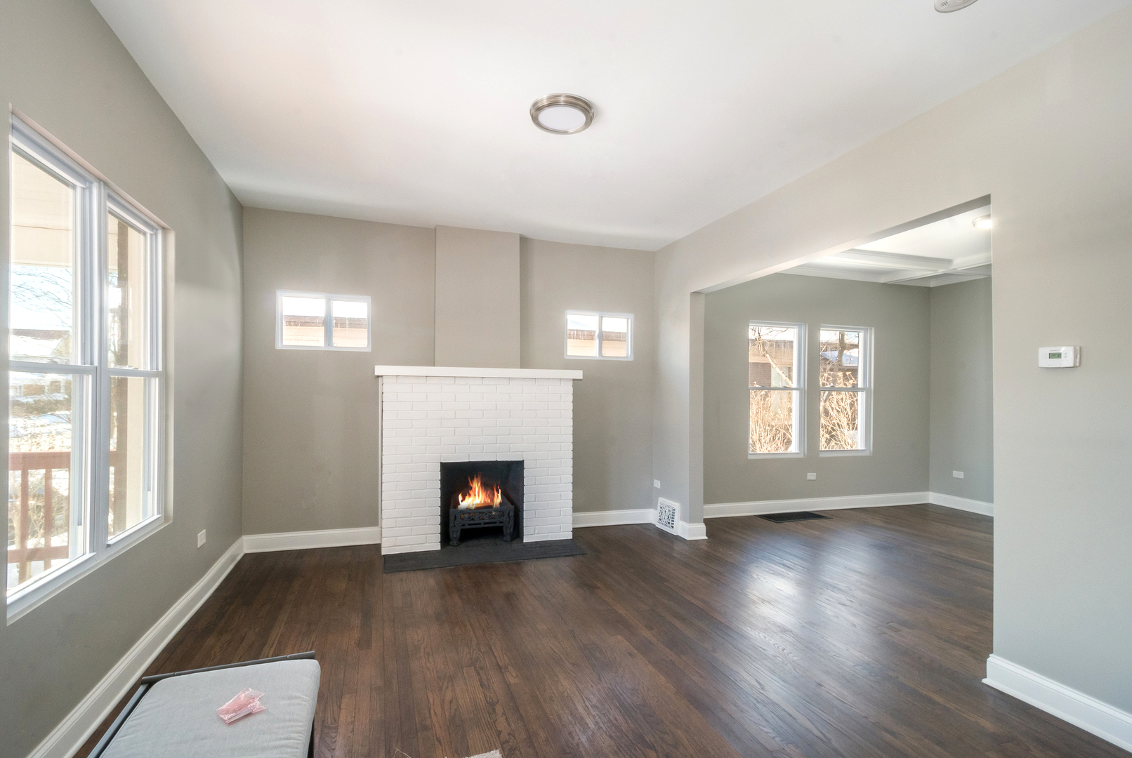 148 East Burlington Street Riverside, IL 60546 - Photo 3 of 16 a view of an empty room with wooden floor and a window