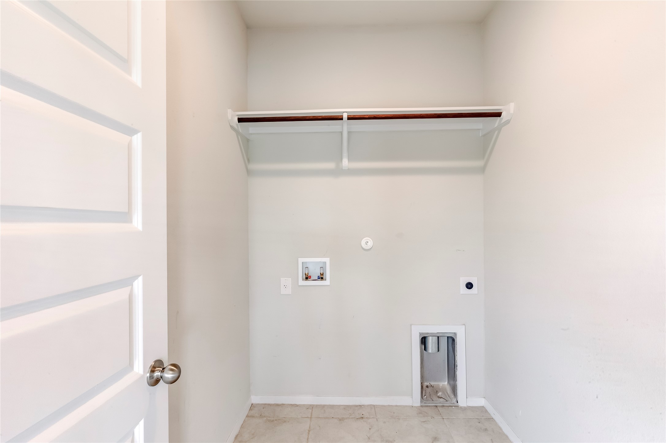 2721 Winding Creek Road Kyle, TX 78640 - Photo 24 of 27 Dedicated utility area featuring a built-in shelf with hanging rod, tile flooring, and essential appliance hookups