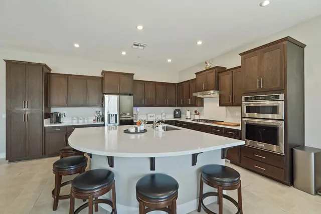 a kitchen that has a sink and a stove