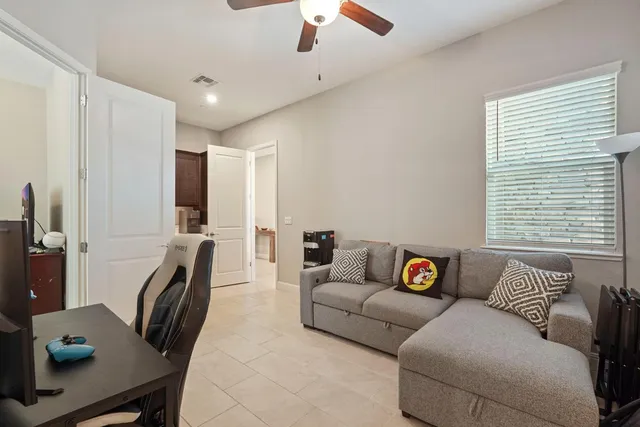 a view of a chair and tables with wooden fence