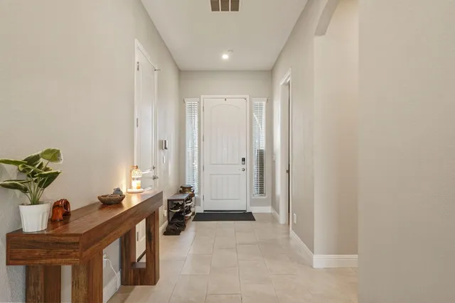 a kitchen with a sink table and chairs
