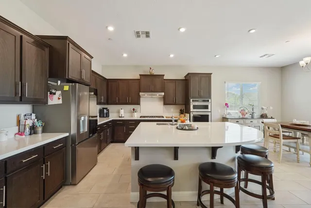 a kitchen with stainless steel appliances granite countertop a sink stove and microwave