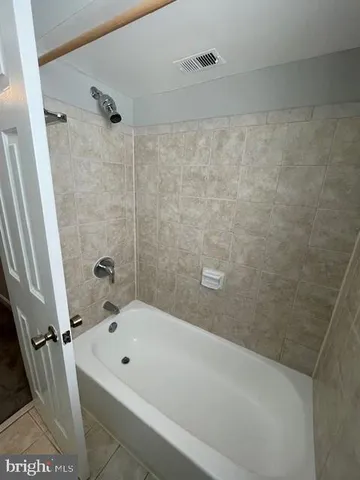 a bathroom with a bathtub and shower