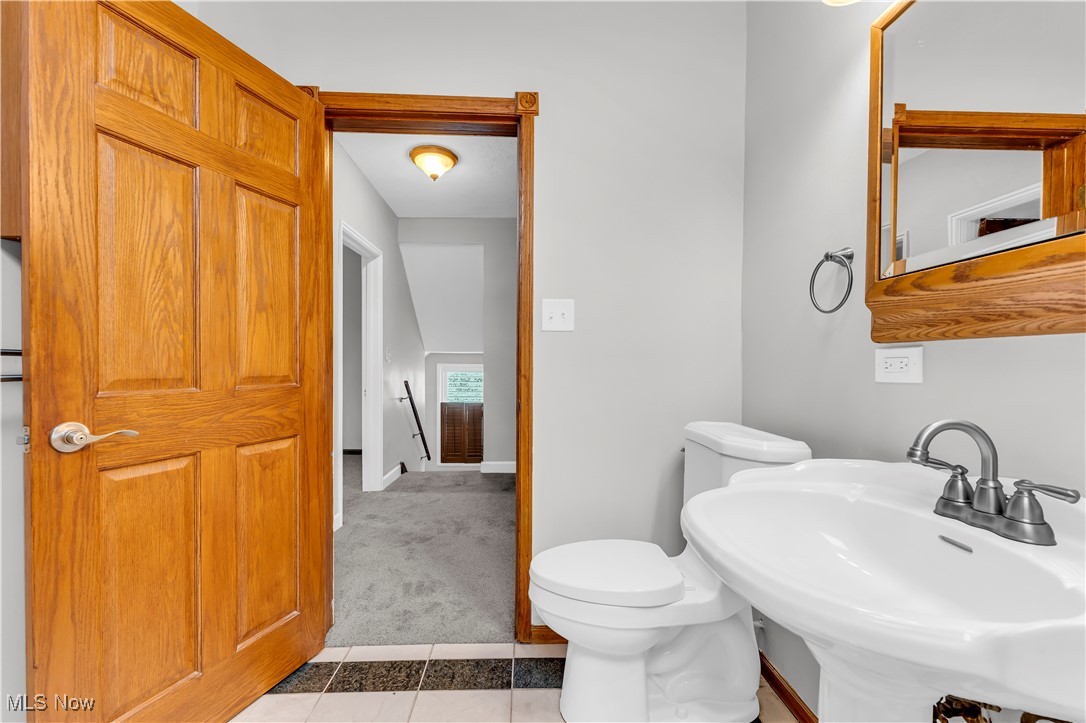 3374 Fulton Road Cleveland, OH 44109 - Photo 18 of 27 Half bathroom with light tile patterned floors and light colored carpet