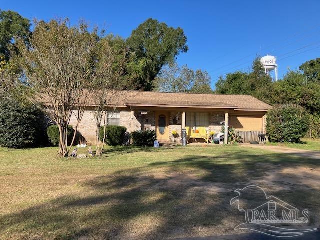 4737 Dean Drive Pace, FL 32571 - Photo 1 of 13 a front view of a house with garden