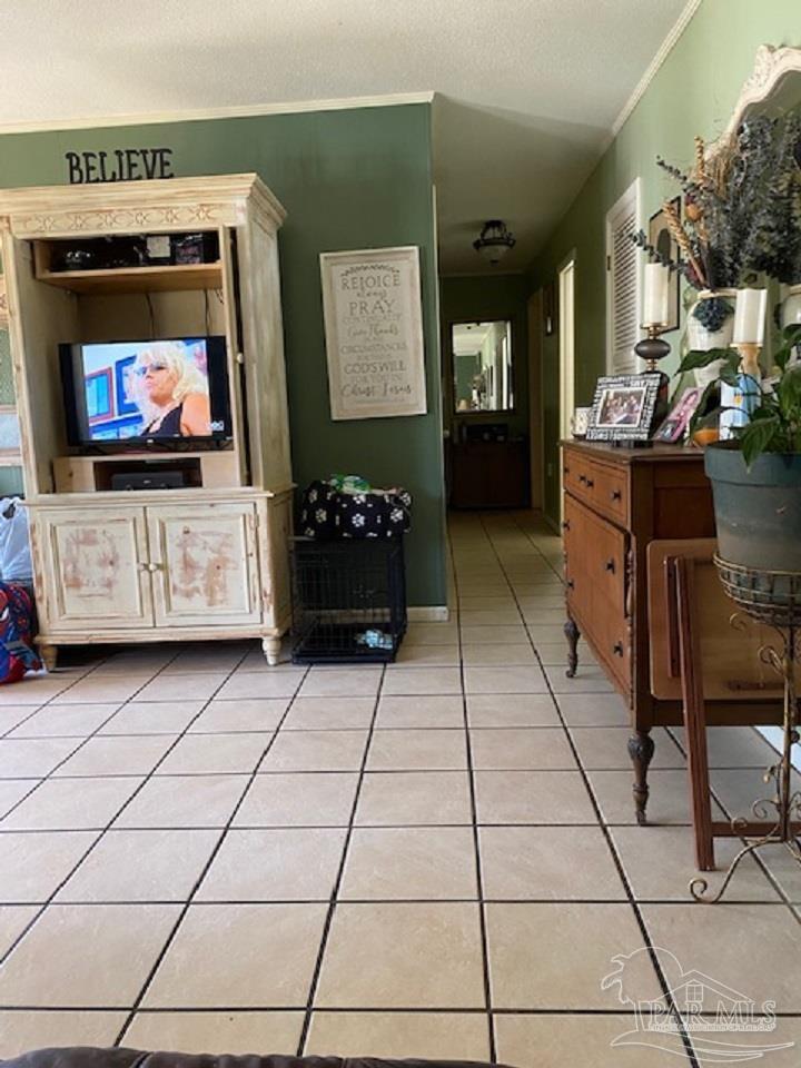 4737 Dean Drive Pace, FL 32571 - Photo 11 of 13 a living room with stainless steel appliances kitchen island granite countertop a rug a stove and a wooden cabinets