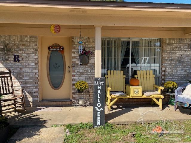 4737 Dean Drive Pace, FL 32571 - Photo 2 of 13 a front view of a house with outdoor seating