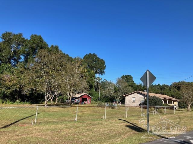 4737 Dean Drive Pace, FL 32571 - Photo 6 of 13 a swimming pool with trees in the background