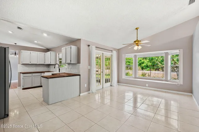 a large kitchen with kitchen island granite countertop a window and a sink