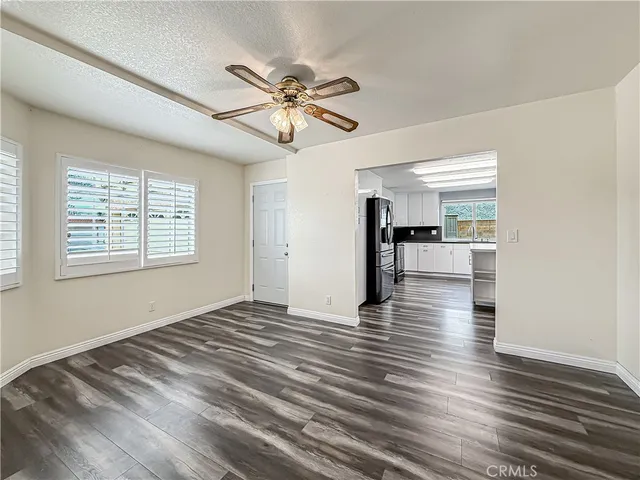 a view of empty room with wooden floor and window