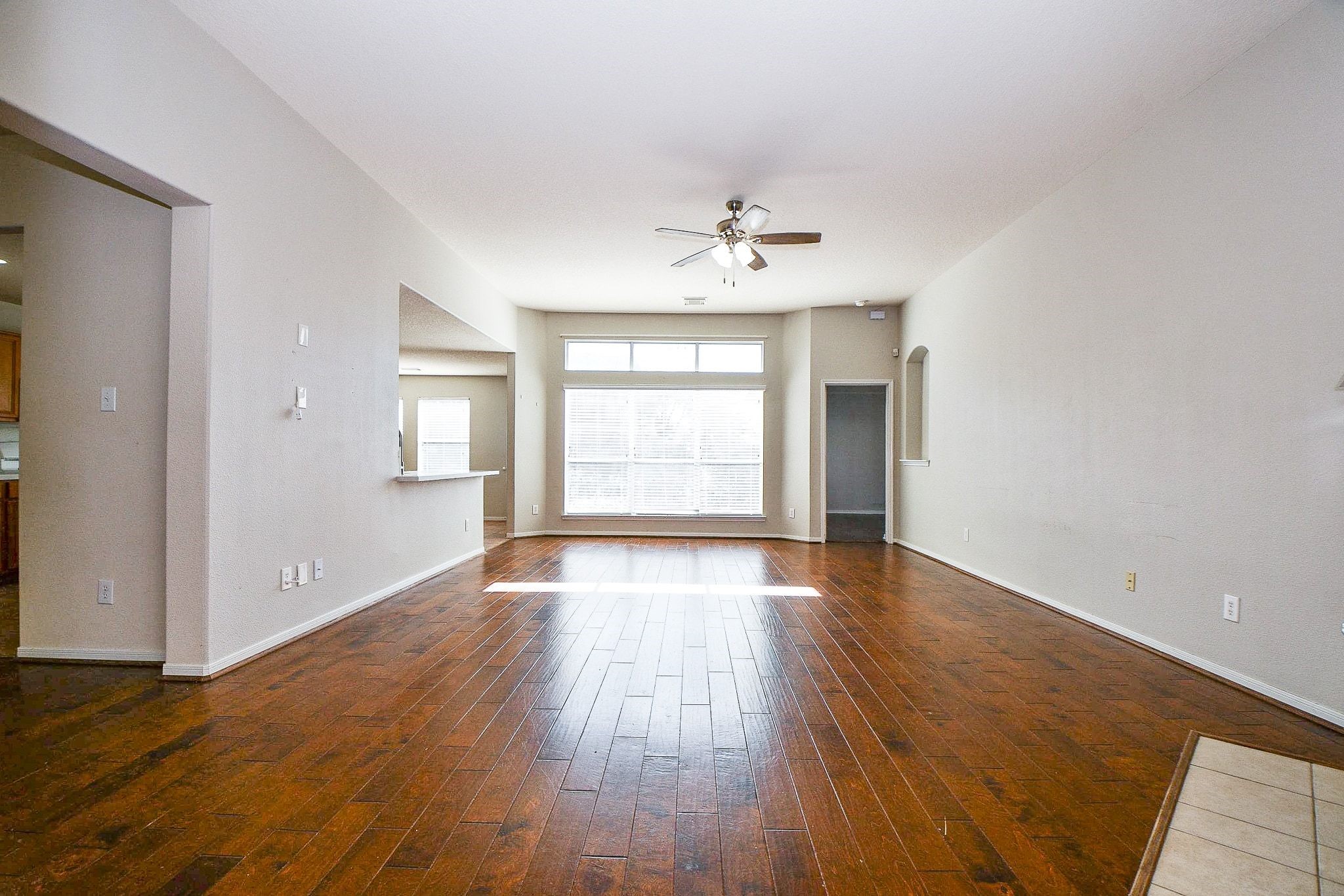 23831 Shaw Perry Lane Katy, TX 77493 - Photo 4 of 20 wooden floor in an empty room with a window
