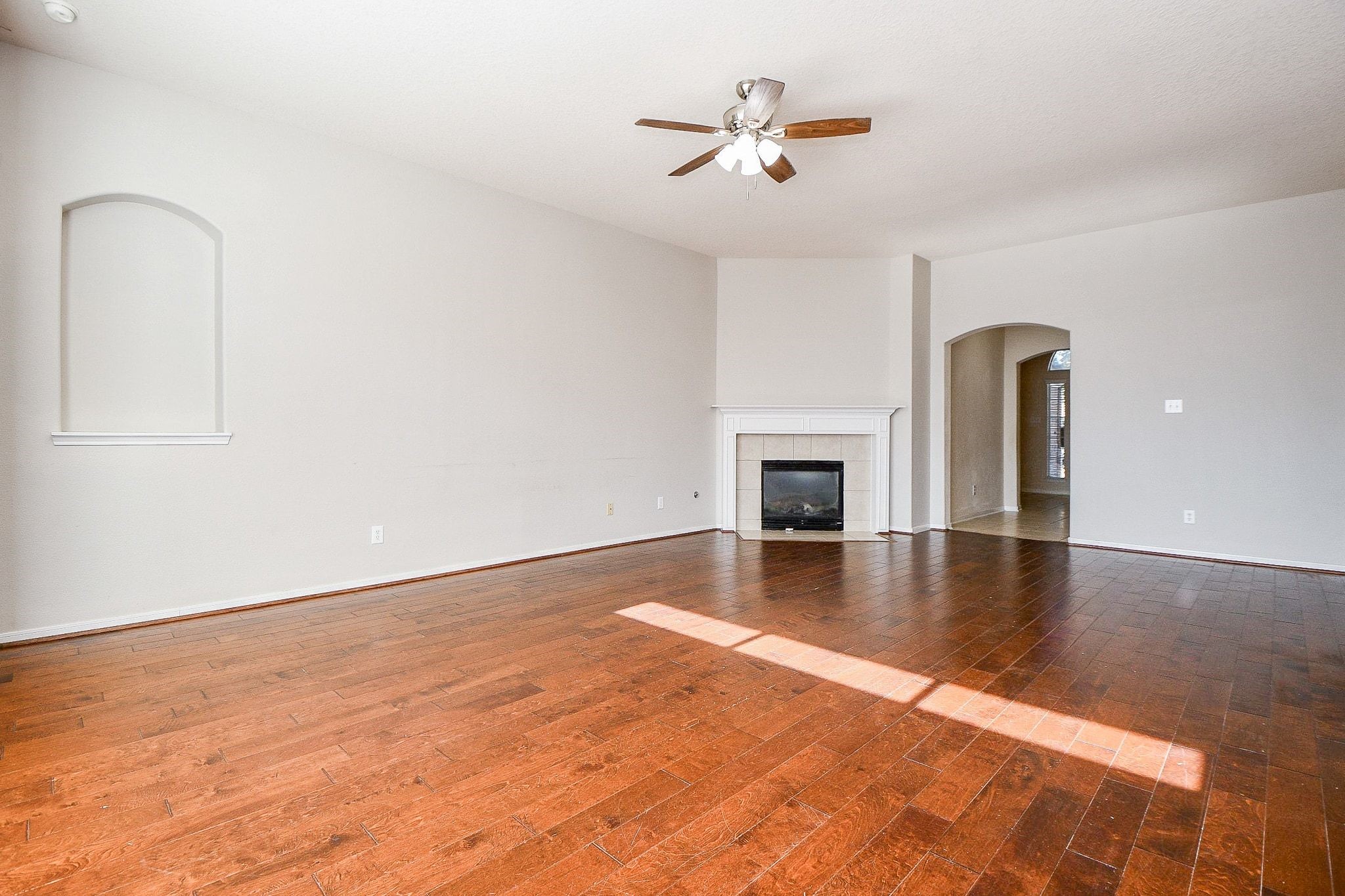 23831 Shaw Perry Lane Katy, TX 77493 - Photo 5 of 20 a view of empty room with wooden floor and fireplace