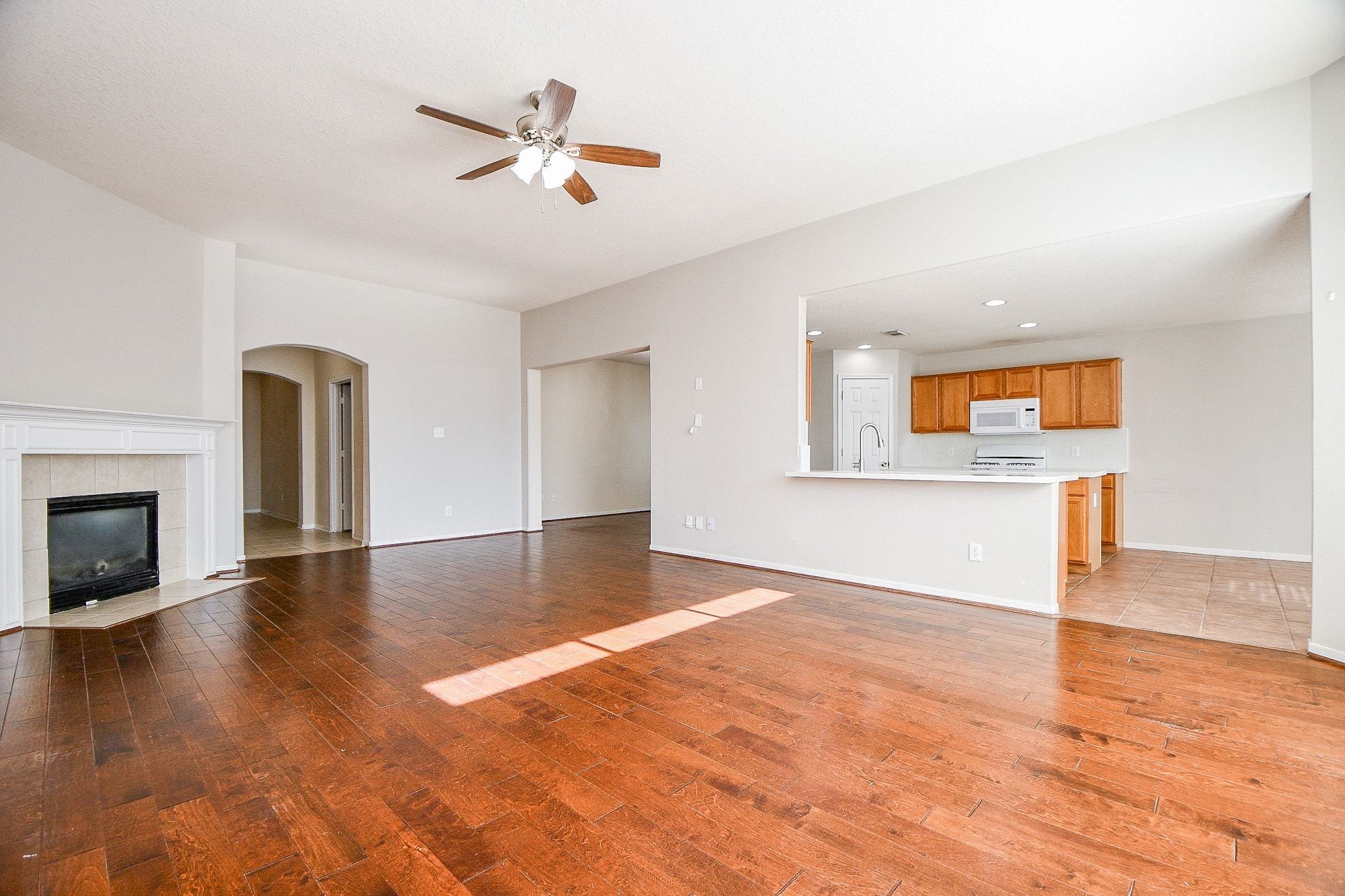 23831 Shaw Perry Lane Katy, TX 77493 - Photo 6 of 20 a view of an empty room with a fireplace and wooden floor