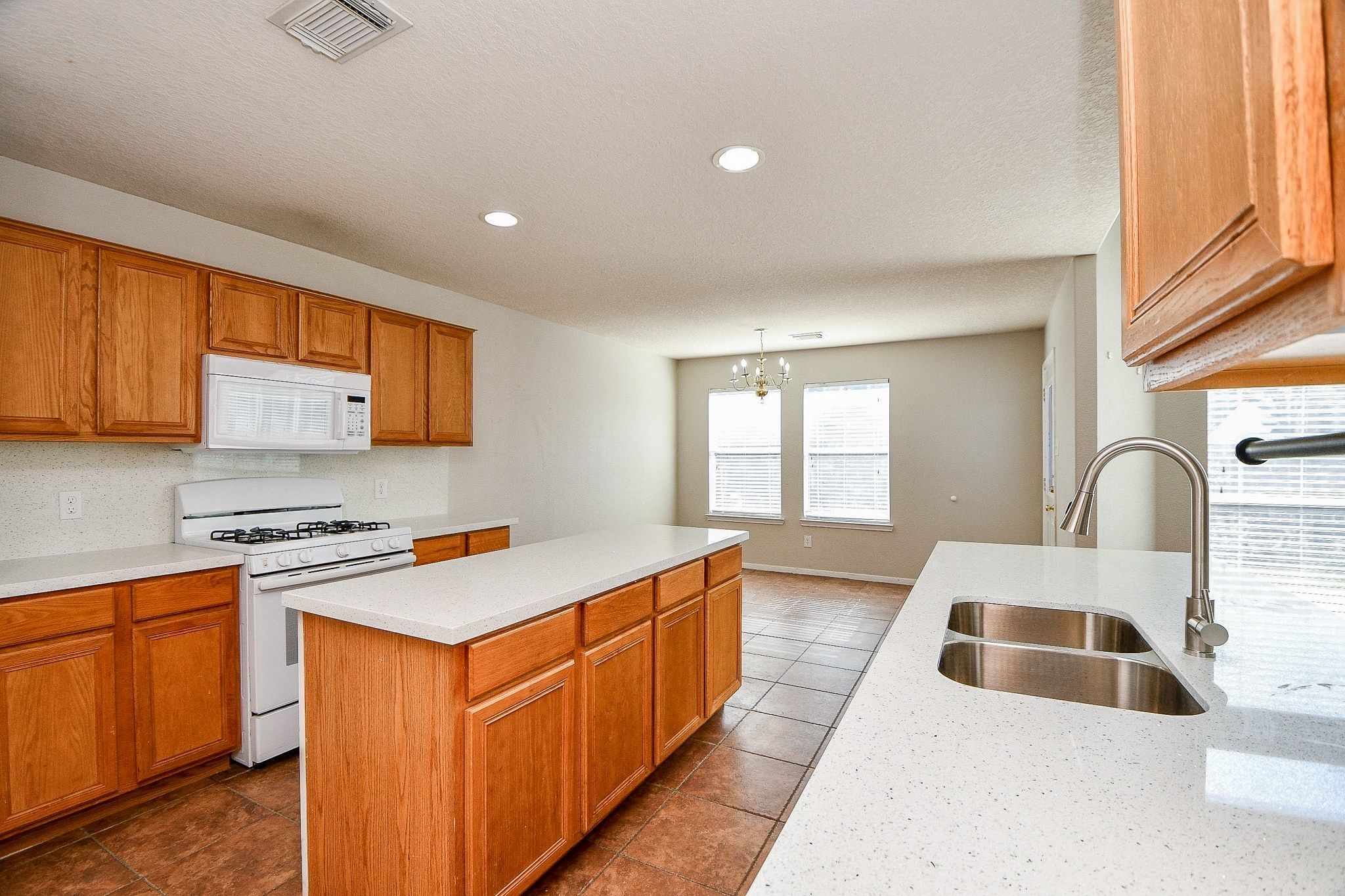 23831 Shaw Perry Lane Katy, TX 77493 - Photo 7 of 20 a kitchen with stainless steel appliances granite countertop a stove a sink a refrigerator and white cabinets with wooden floor