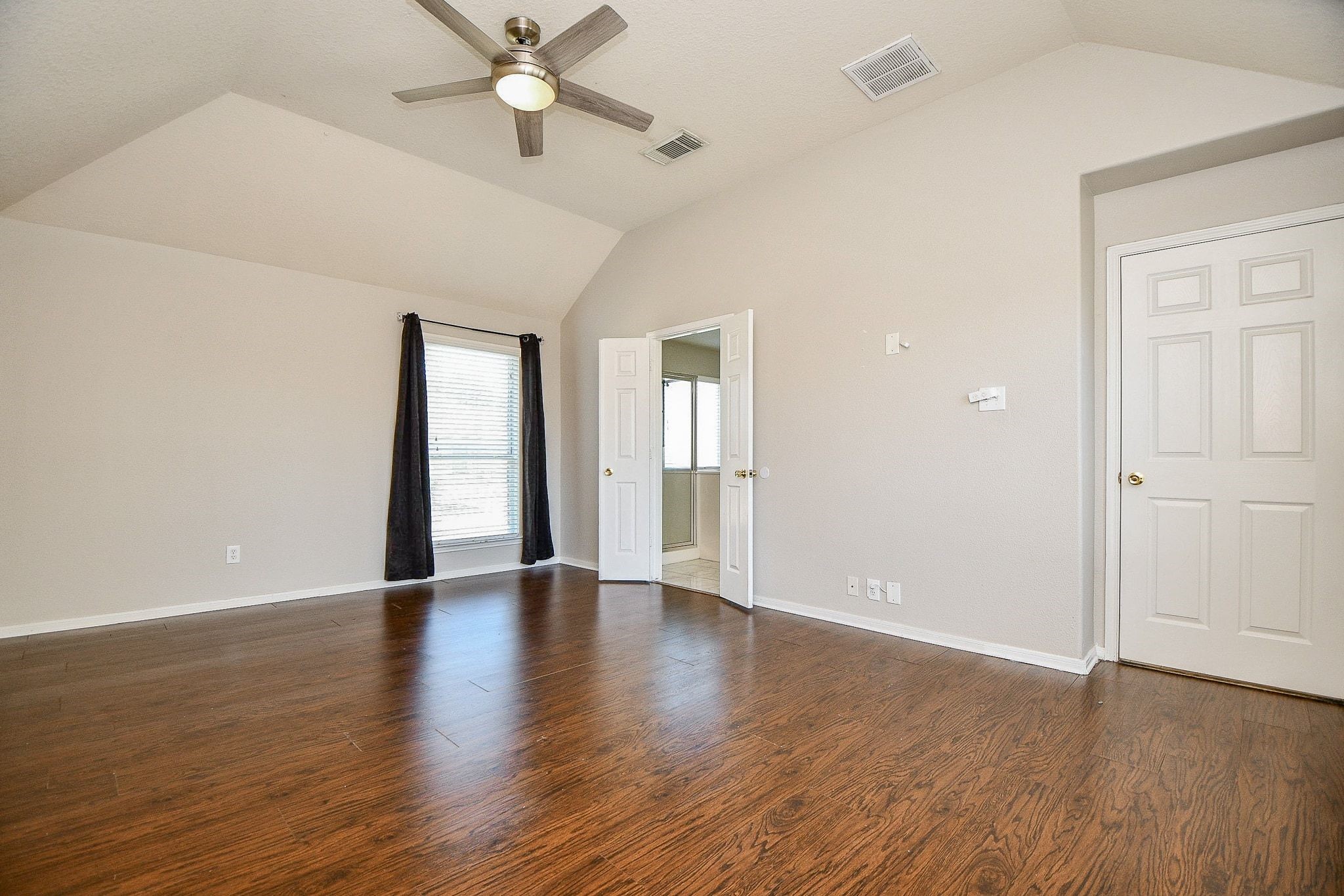 23831 Shaw Perry Lane Katy, TX 77493 - Photo 10 of 20 an empty room with wooden floor chandelier fan and windows