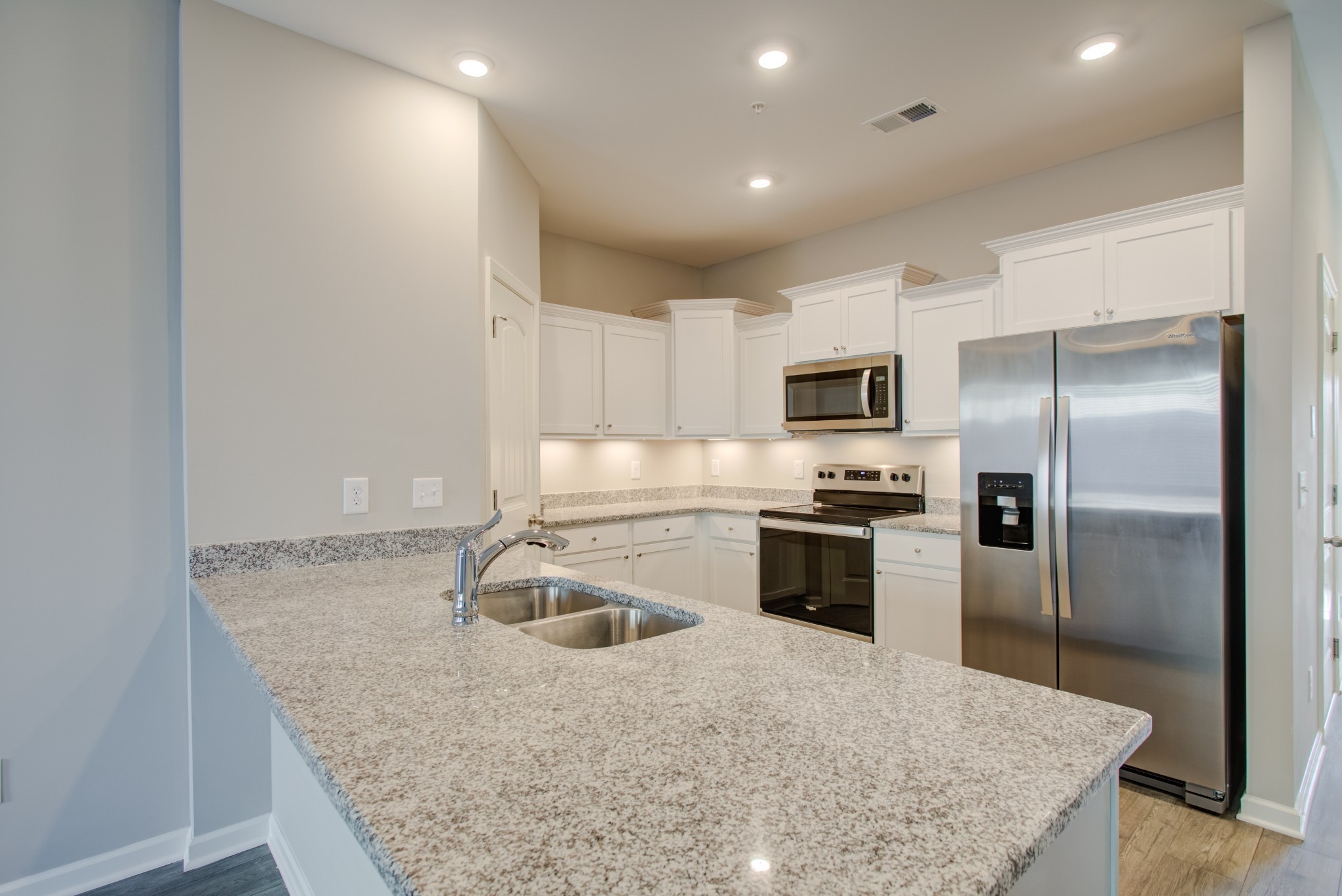 132 Grand Avenue Spring Hill, TN 37174 - Photo 2 of 11 a kitchen with kitchen island granite countertop a sink stove and refrigerator