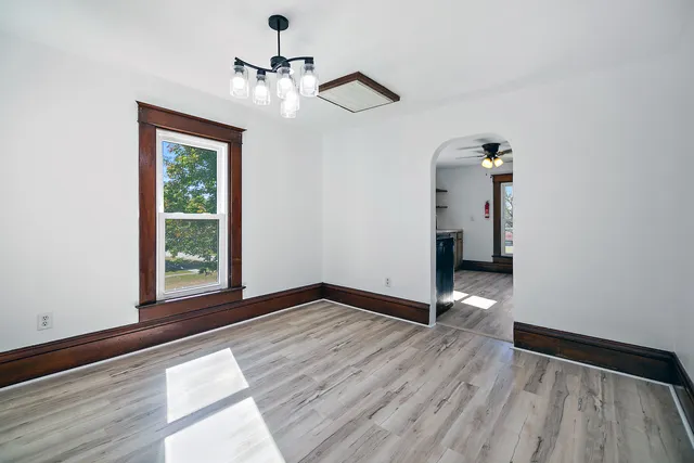wooden floor in an empty room with a window