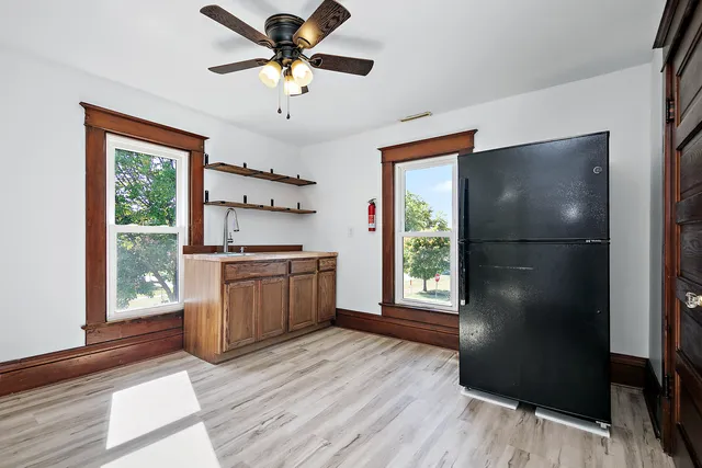 a kitchen with a refrigerator a sink and dishwasher with wooden floor