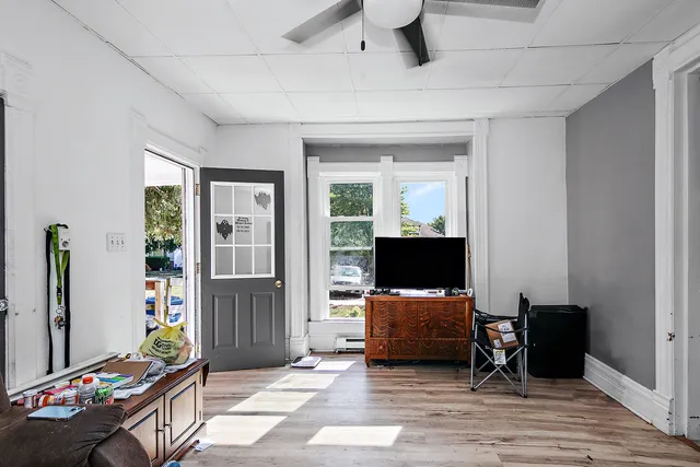 a view of a livingroom with workspace and a window