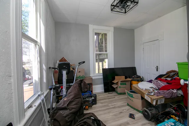 a view of a workspace with furniture and a window