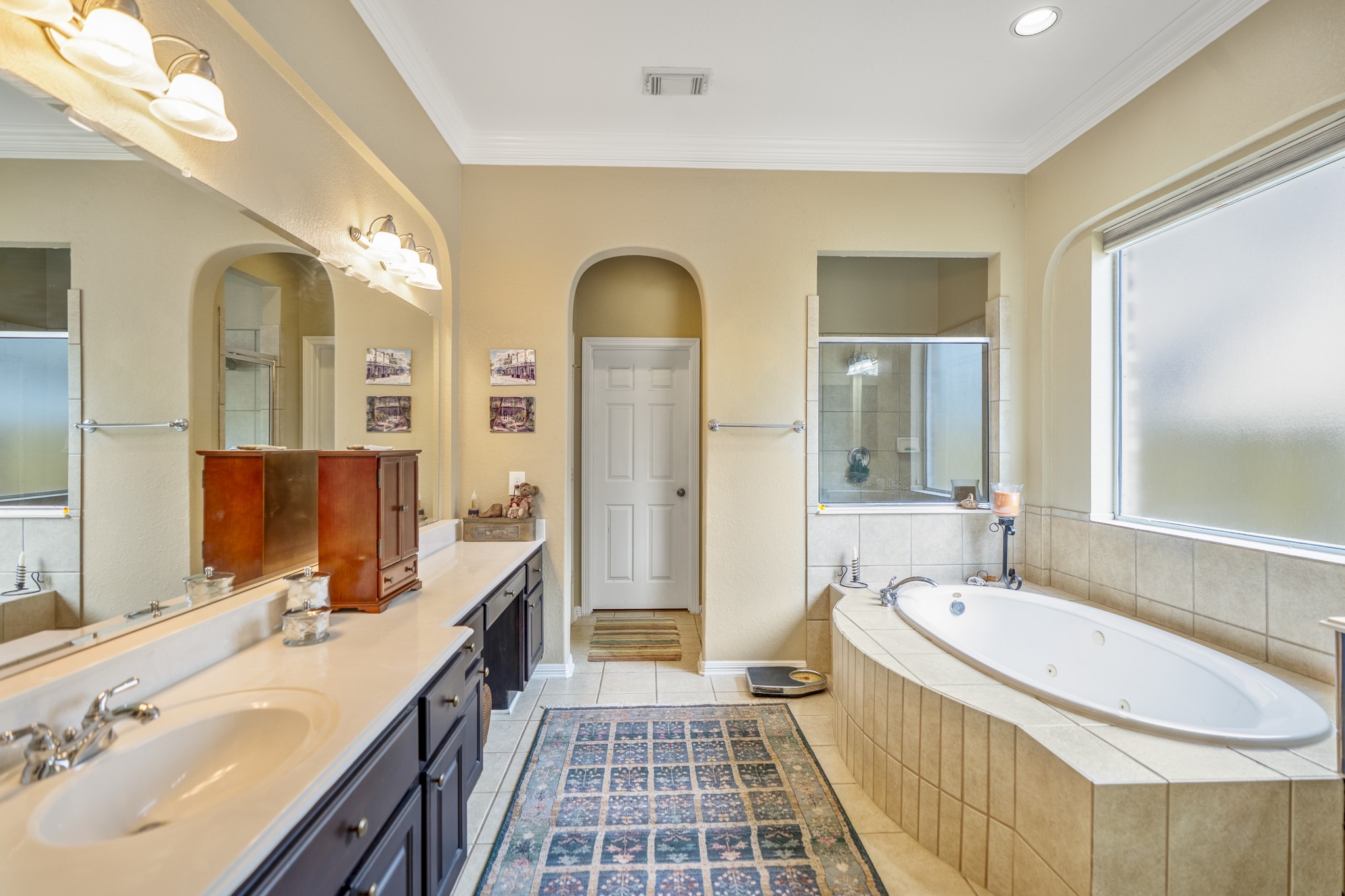 1438 Hatchmere Place Spring, TX 77379 - Photo 19 of 50 The en-suite bathroom features dual sinks, a large vanity area, a separate shower, and whirlpool tub.
