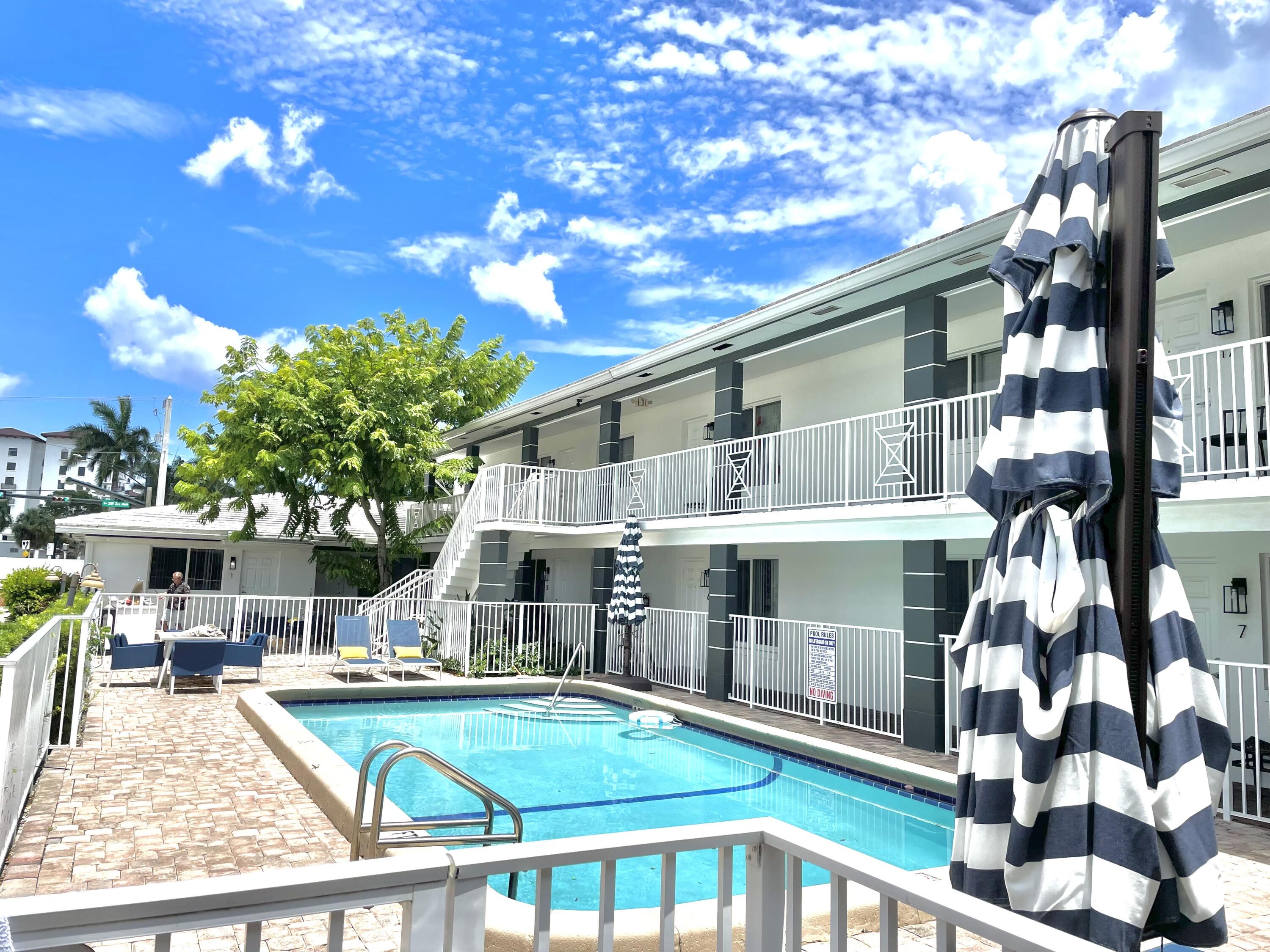 a view of house with swimming pool outdoor seating
