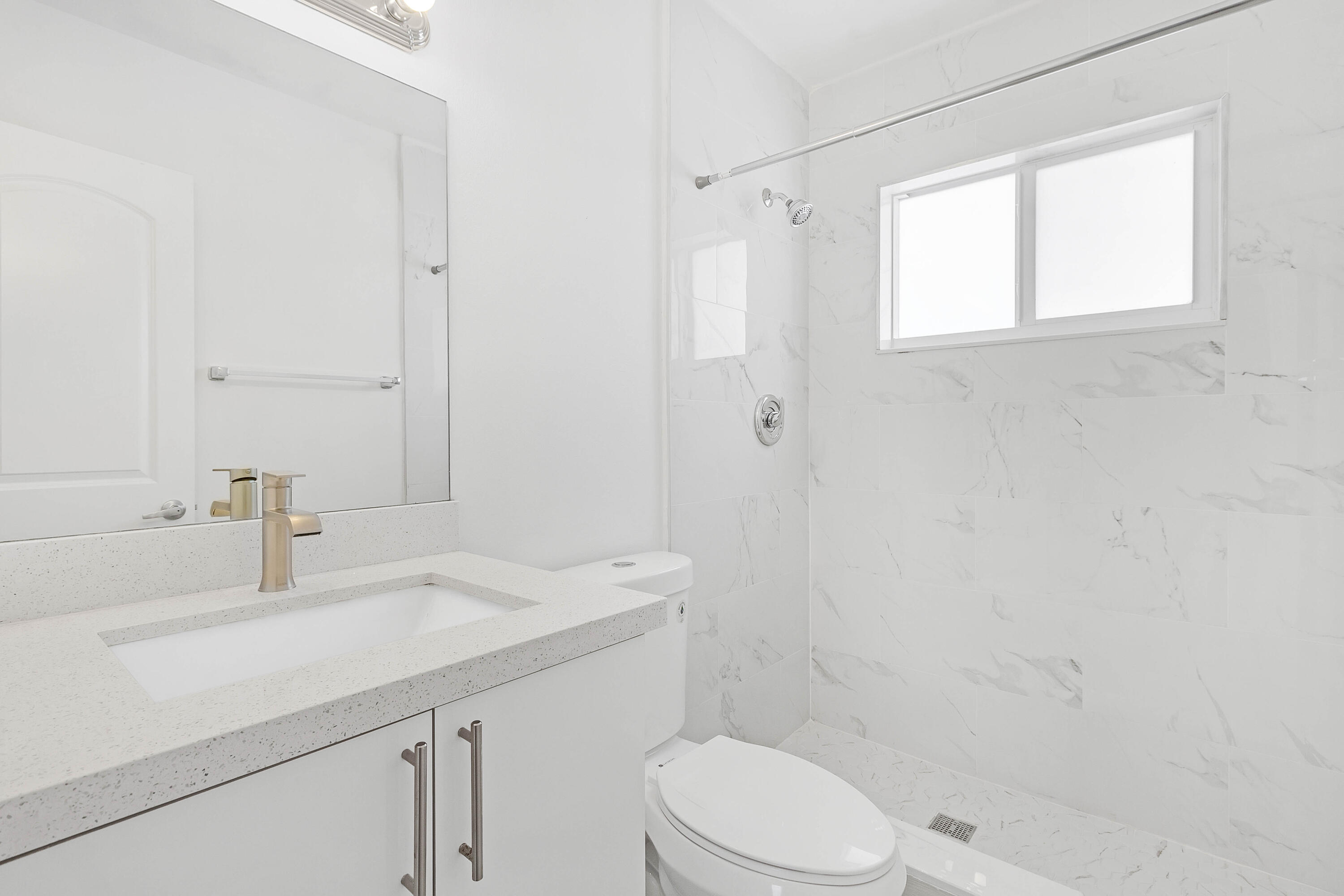 330 West Camino Real Boca Raton, FL 33432 - Photo 16 of 18 a bathroom with a sink a toilet and shower