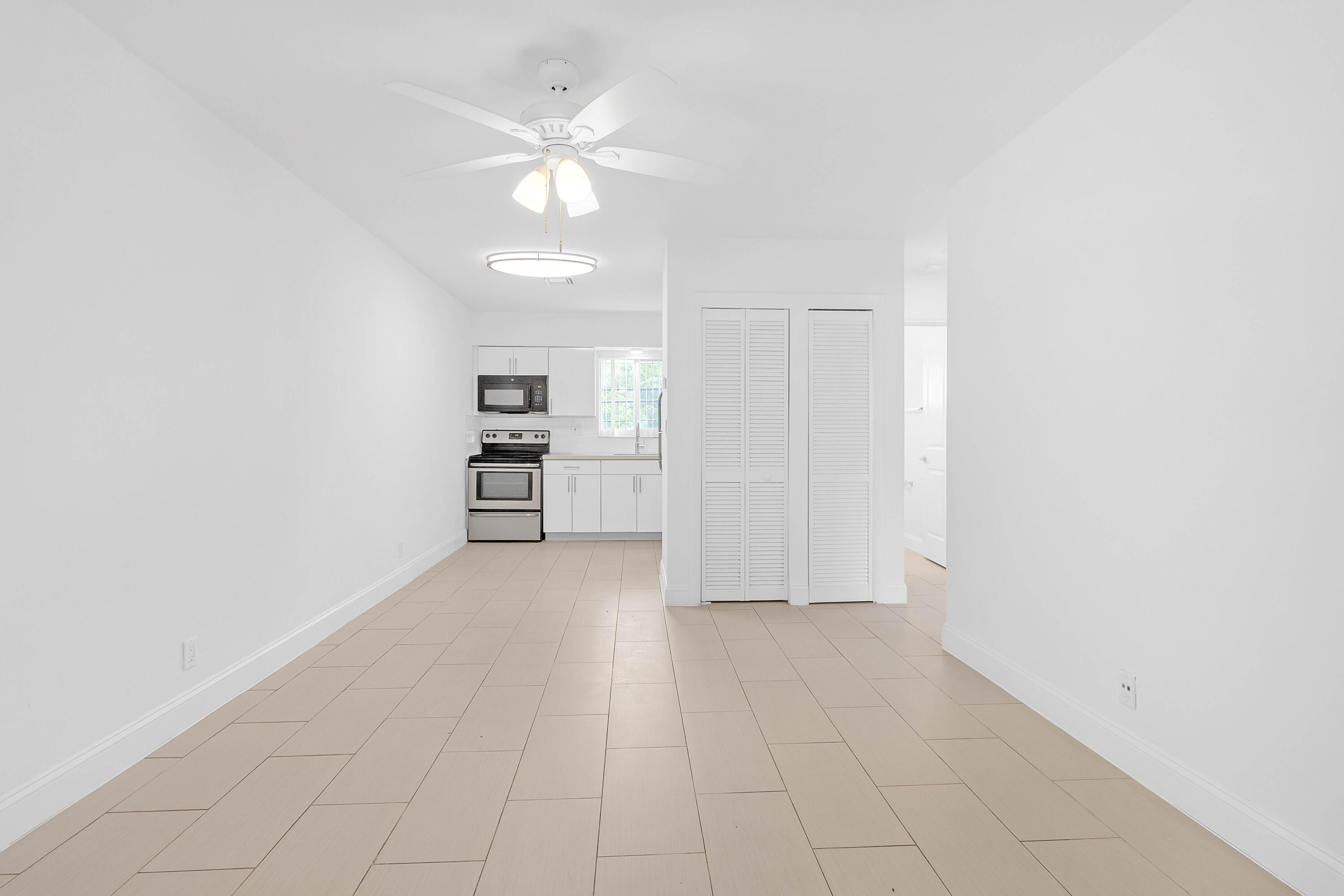 330 West Camino Real Boca Raton, FL 33432 - Photo 8 of 18 wooden floor in an empty room with a window