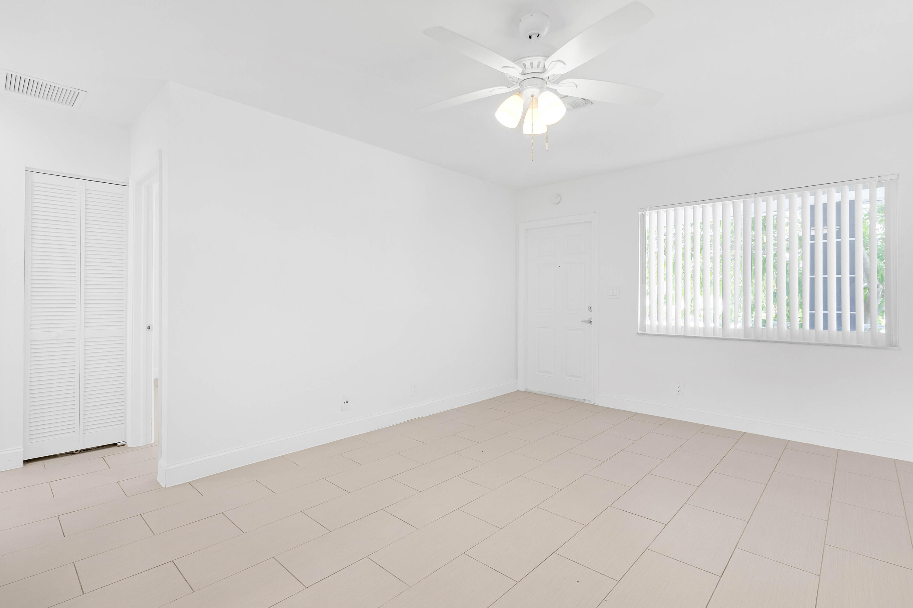 330 West Camino Real Boca Raton, FL 33432 - Photo 10 of 18 an empty room with a window and a ceiling fan