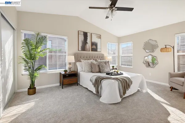 a spacious bedroom with a bed and a couch