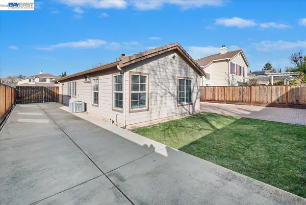 a view of a house with a yard and deck