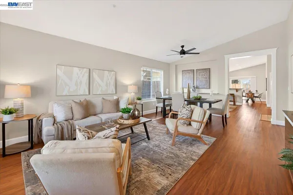 a living room with furniture and wooden floor