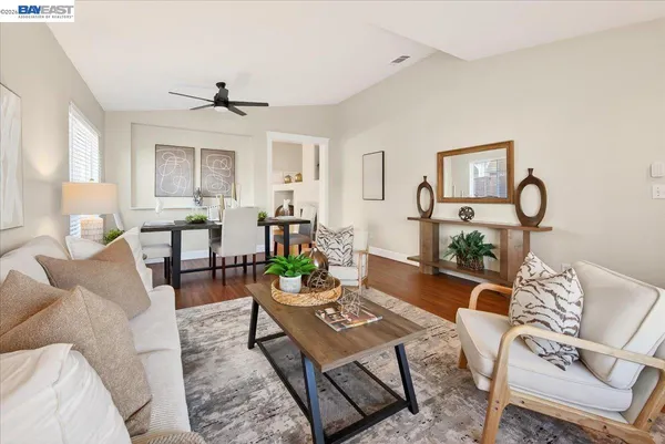 a living room with furniture and wooden floor