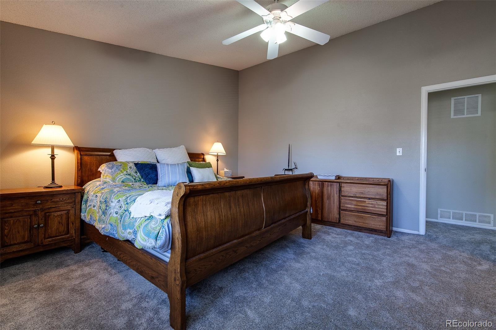 462 Mountain Chickadee Road Highlands Ranch, CO 80126 - Photo 15 of 37 a bedroom with a bed and a chandelier