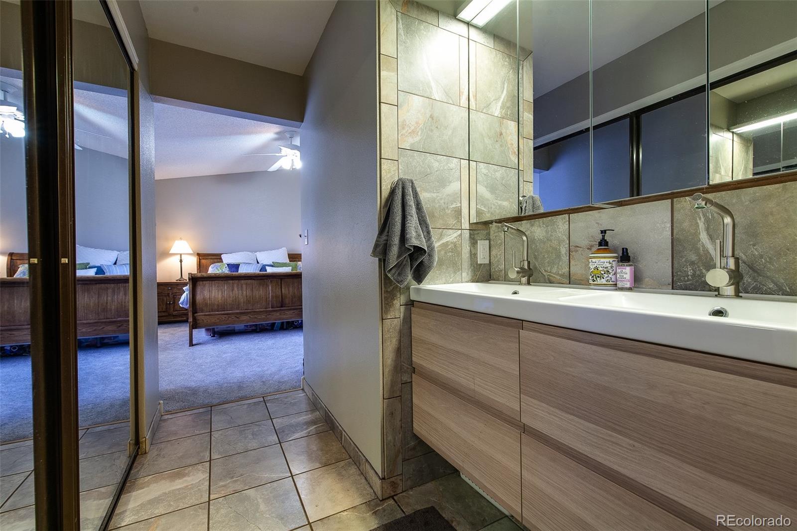 462 Mountain Chickadee Road Highlands Ranch, CO 80126 - Photo 17 of 37 a bathroom with a sink and a mirror