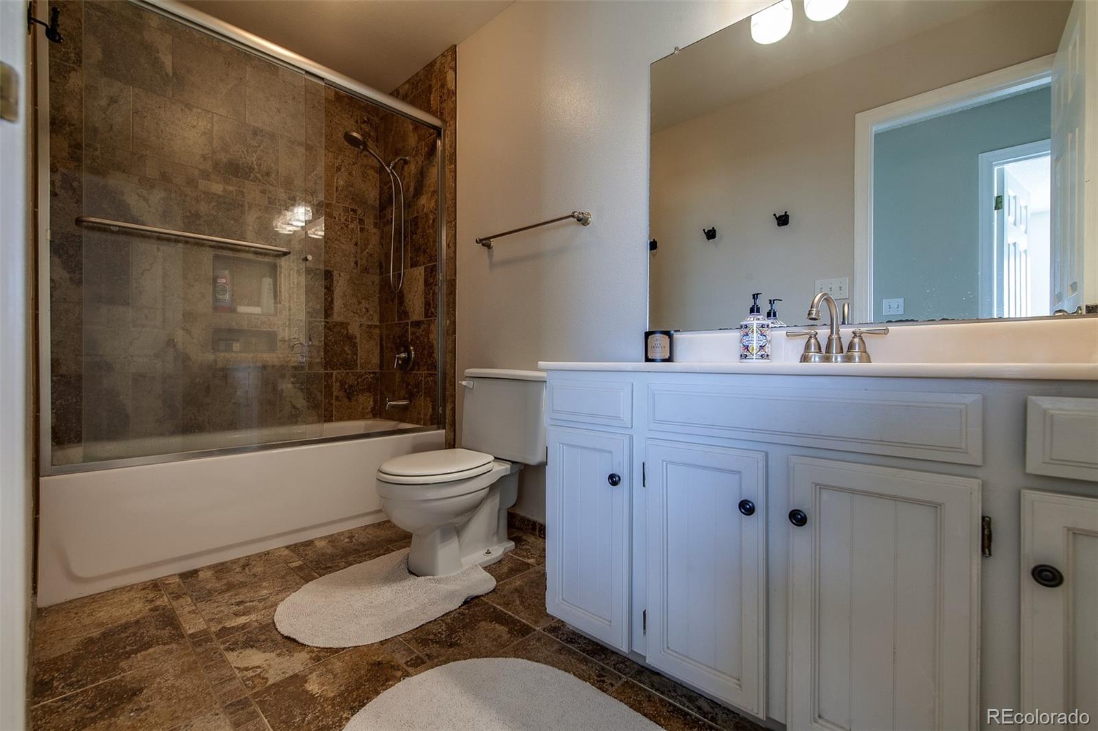 462 Mountain Chickadee Road Highlands Ranch, CO 80126 - Photo 21 of 37 a bathroom with a sink toilet and shower