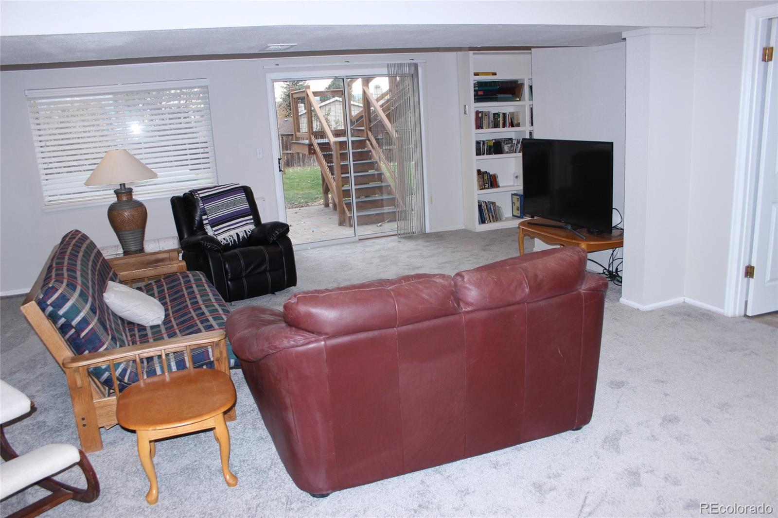 462 Mountain Chickadee Road Highlands Ranch, CO 80126 - Photo 22 of 37 a living room with furniture and a flat screen tv