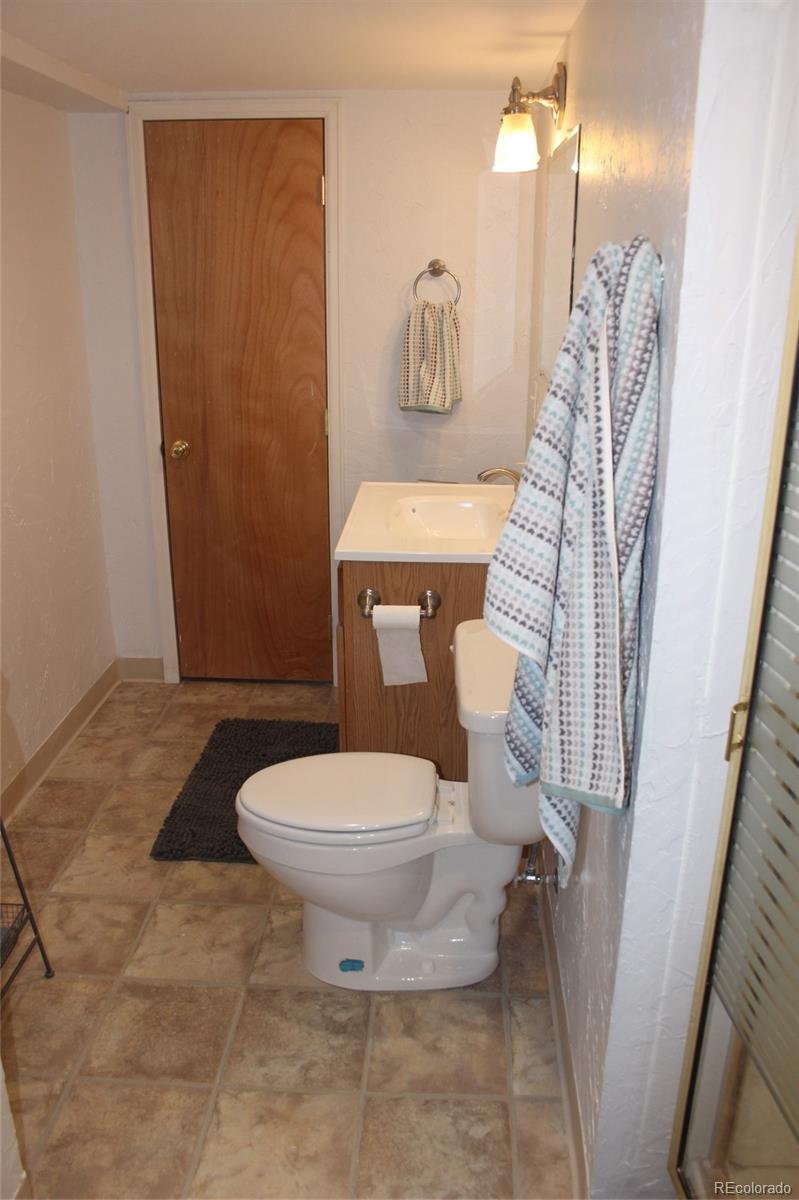 462 Mountain Chickadee Road Highlands Ranch, CO 80126 - Photo 25 of 37 a white toilet sitting next to a shower curtain