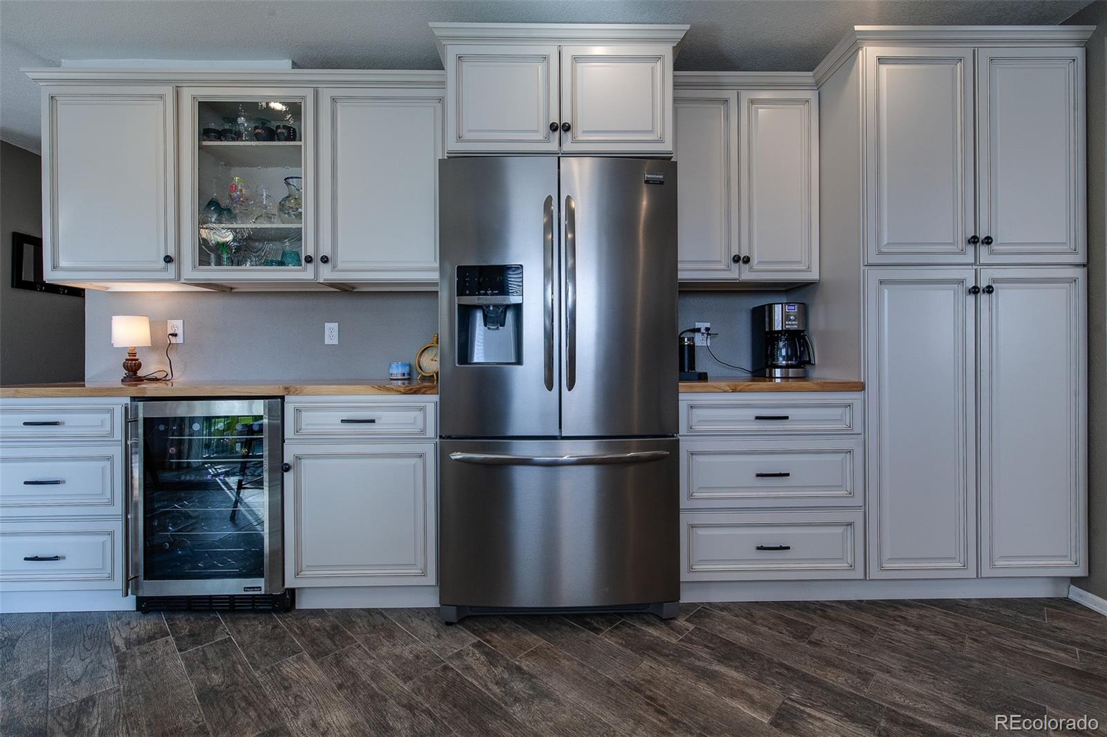 462 Mountain Chickadee Road Highlands Ranch, CO 80126 - Photo 8 of 37 a kitchen with cabinets and stainless steel appliances
