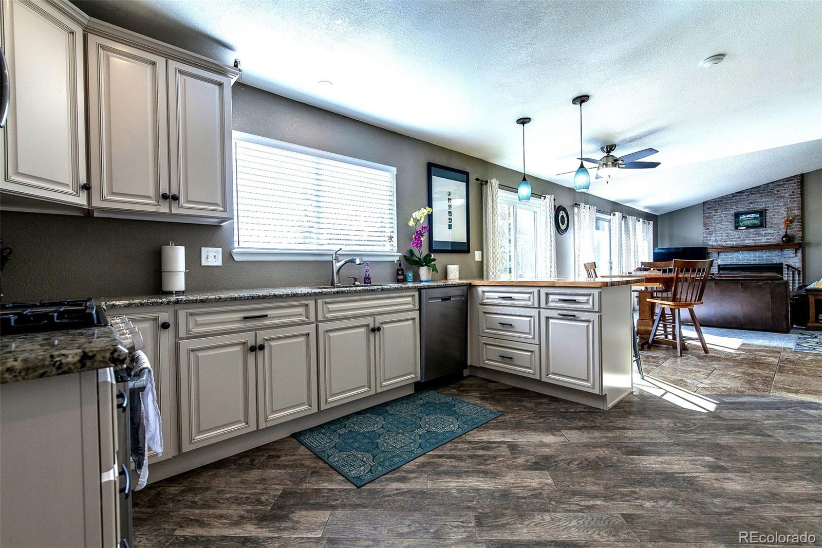 462 Mountain Chickadee Road Highlands Ranch, CO 80126 - Photo 9 of 37 a kitchen with stove cabinets and window