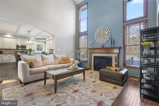 a dining room with furniture and a floor to ceiling window