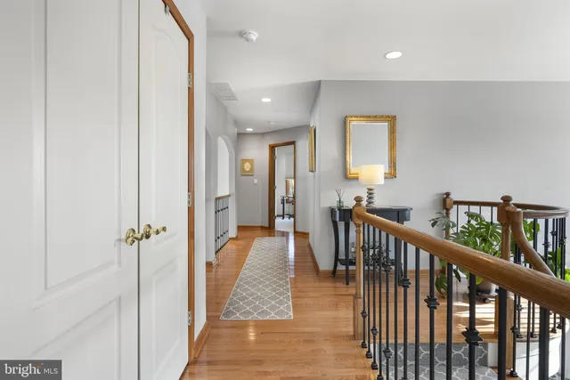 a bedroom with a bed and large windows