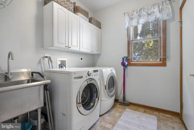 a bathroom with a double vanity sink and a mirror
