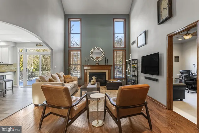 a living room with furniture a fireplace and a large window