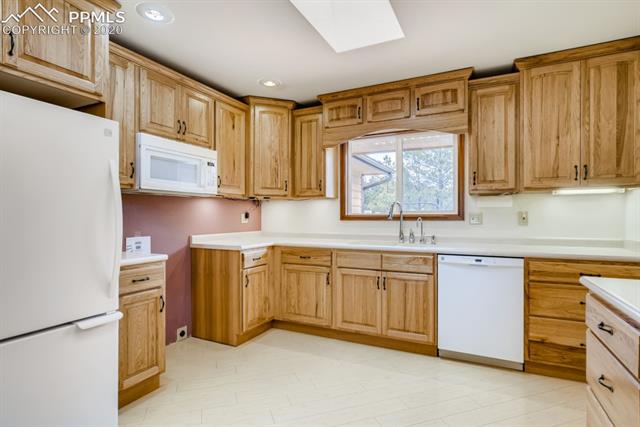7575 Tobin Road Colorado Springs, CO 80908 - Photo 6 of 27 Large country kitchen- new stove coming!