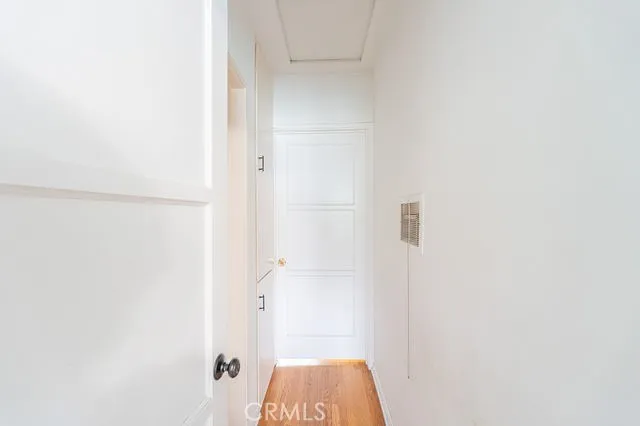 a storage room with lots of clutter and white cabinets