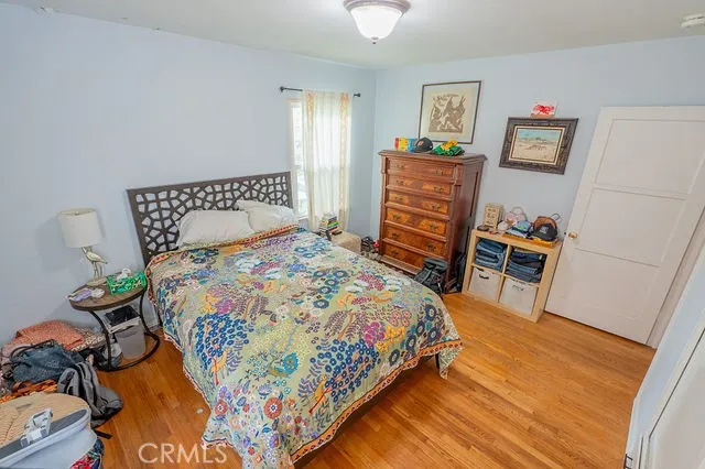 a bedroom with a bed and a dresser in it