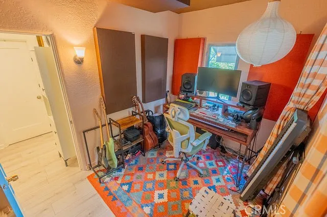 a view of a workspace with furniture and a window